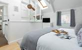 The light and airy bedroom has original beams and a vaulted ceiling.  - Thumbnail Image