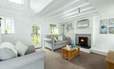 The light and airy living area leads out to the decking and the pretty garden. - Thumbnail Image