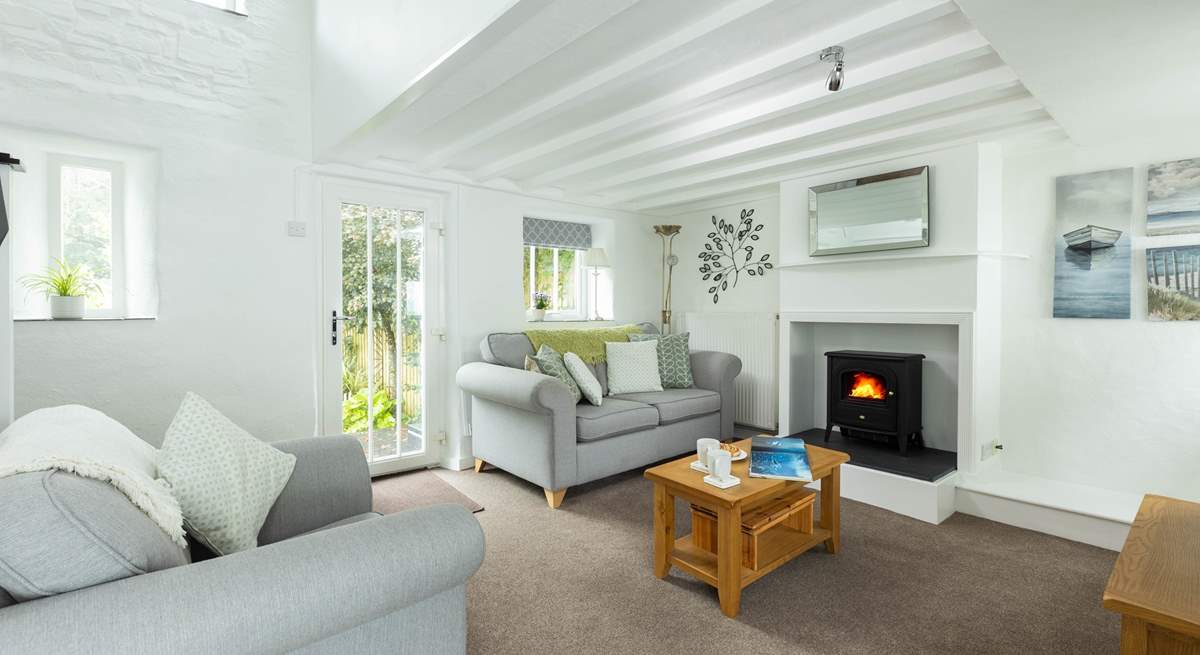 The light and airy living area leads out to the decking and the pretty garden.