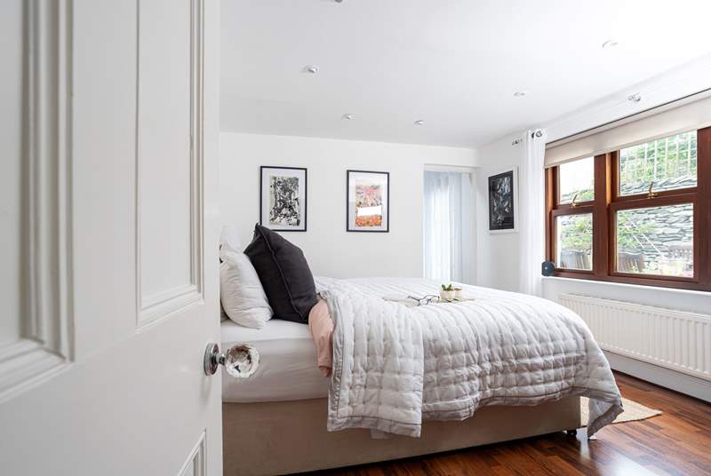 The ground floor bedroom with a comfy 'zip and link' super-king bed looks over the courtyard garden and boasts a stylish en suite.