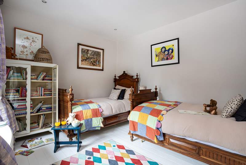 Pretty throws and a colourful rug in the twin bedroom will make any child smile.