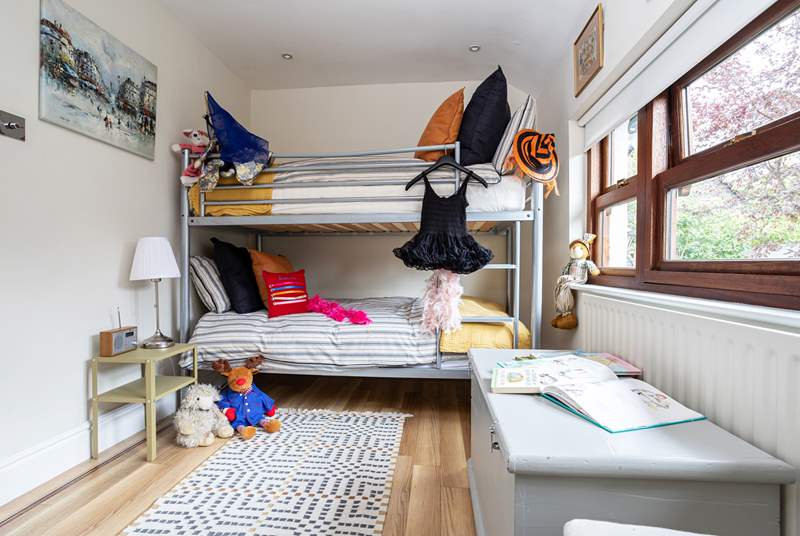 The children's dressing up box is full of treasures and makes this bunk bedroom a haven for fun and frolics. 