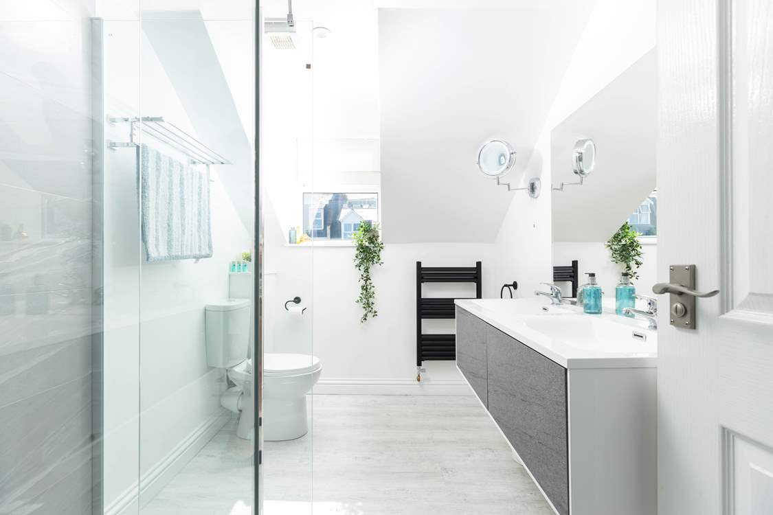 The sleek shower-room with twin wash-basins.