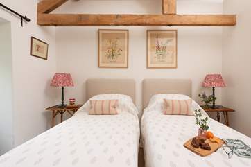 Charming floral prints adorn the wall in bedroom 3