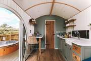 Warm wooden tones and deep forest greens create the cosiest space.