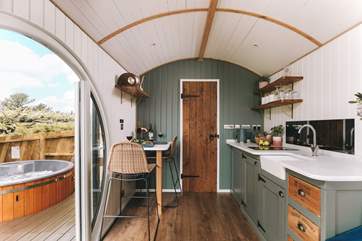 Warm wooden tones and deep forest greens create the cosiest space.