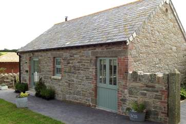The cottage has a private garden, as well as a shared children's play area and an orchard.
