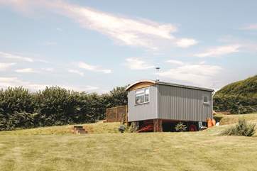 You'll find the hut perched atop a pretty meadow.