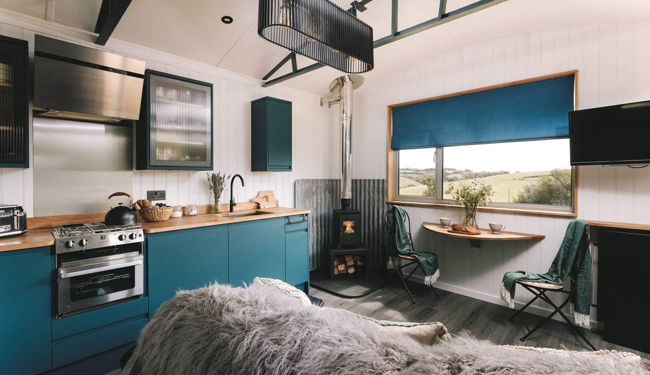 Deep blue tones and warm lighting create a cosy ambience. 