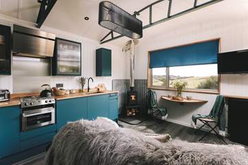 Deep blue tones and warm lighting create a cosy ambience.