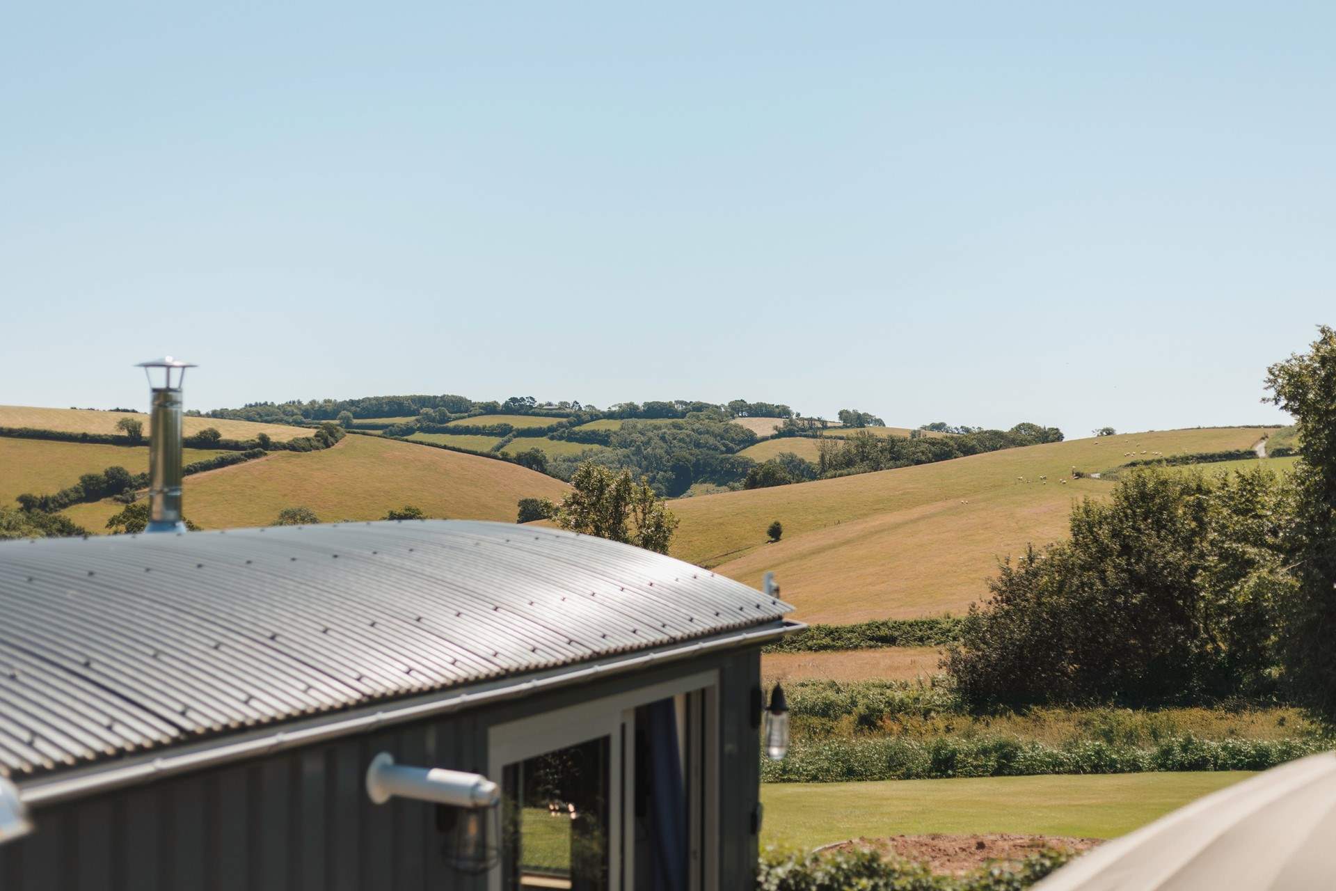 You'll find the hut perched atop a pretty meadow, settled within the gentle rolling hills of rural south Devon.