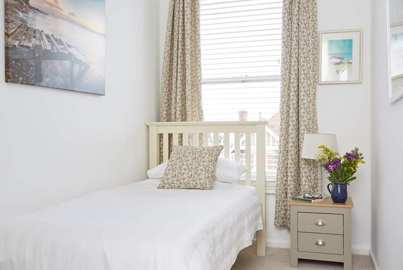 The cosy third bedroom has a single bed which is perfect for an adult or child. 