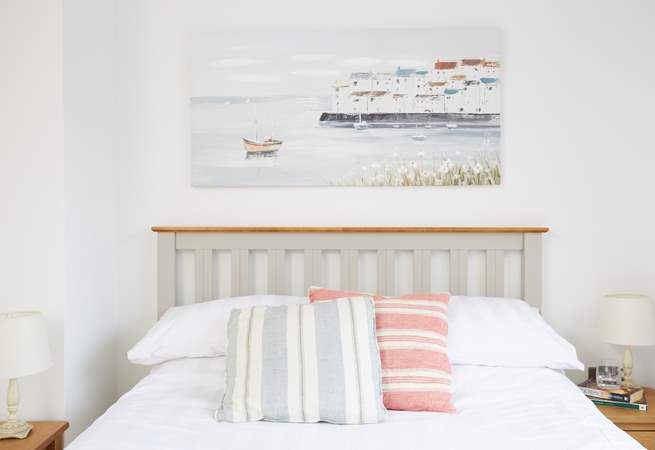 The pretty and bright second bedroom overlooks the garden at Sanderling.