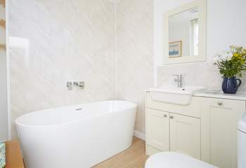 The modern family bathroom on the first floor is just the space for a long relaxing soak.