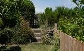 Three steps up and follow the path to the left into the rear secret garden and raised deck. - Thumbnail Image