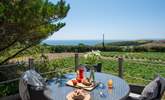 Lunch on the raised deck with views across the fields to the sparkling blue sea beyond. - Thumbnail Image