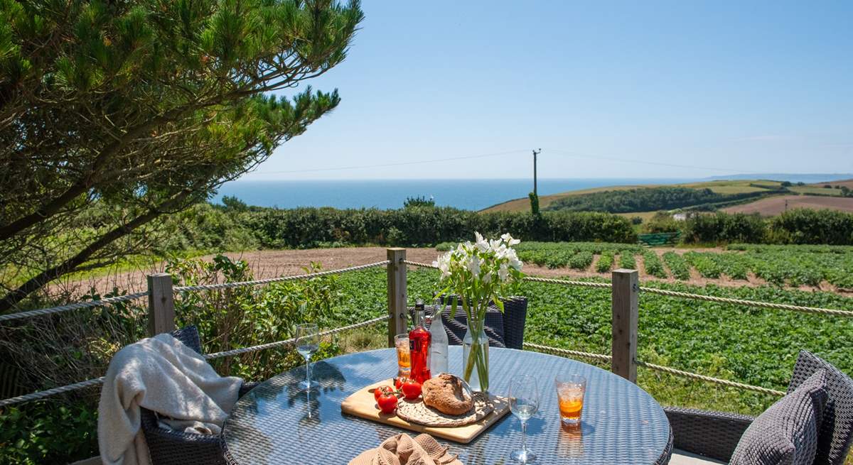 Lunch on the raised deck with views across the fields to the sparkling blue sea beyond.