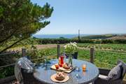 Lunch on the raised deck with views across the fields to the sparkling blue sea beyond.