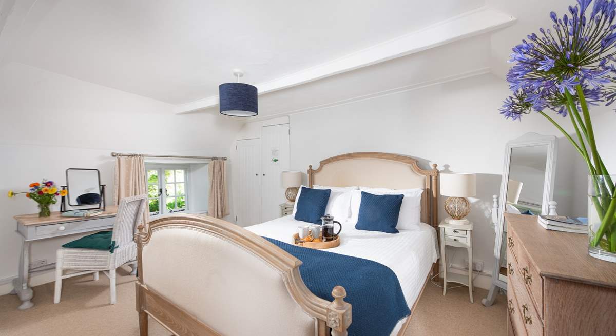 The lovely main bedroom is furnished with a gorgeous French-style, king-size bed.