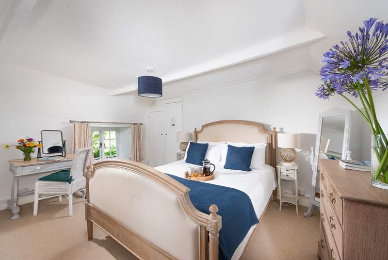 The lovely main bedroom is furnished with a gorgeous French-style, king-size bed.