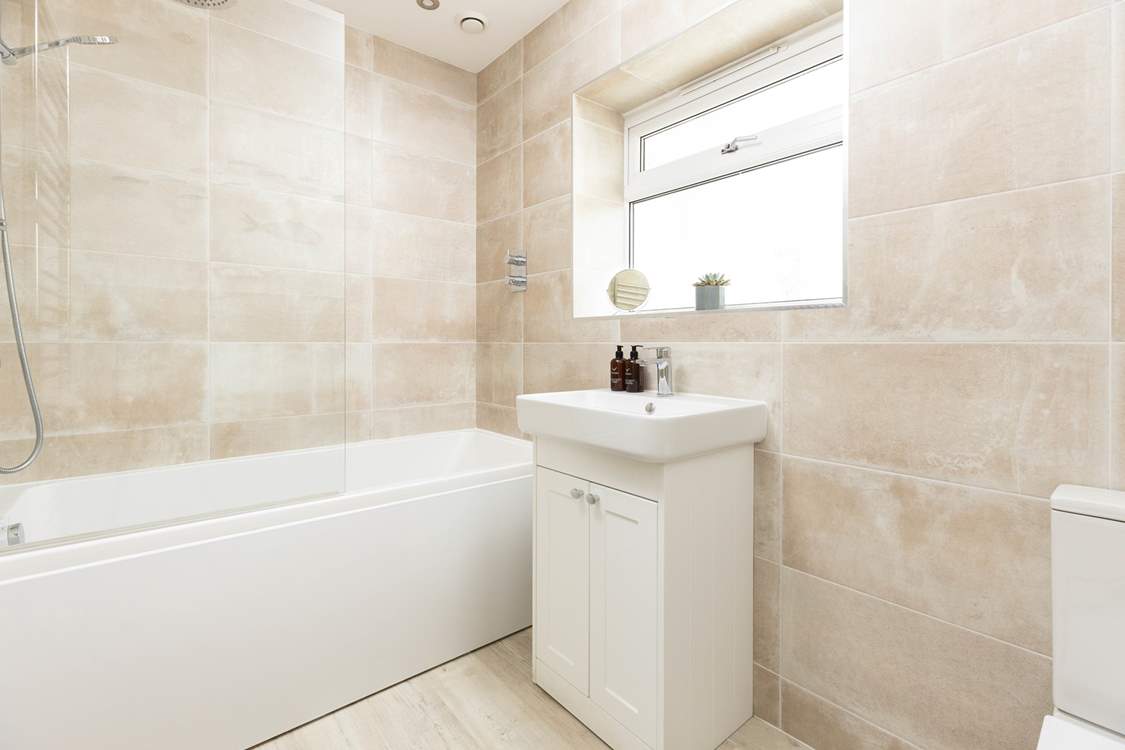 The family bathroom has a bath with shower overhead.