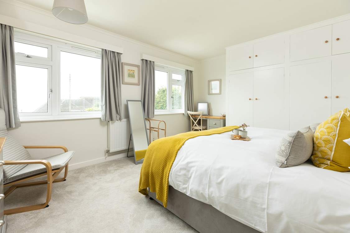 The spacious double aspect bedroom is flooded with light.