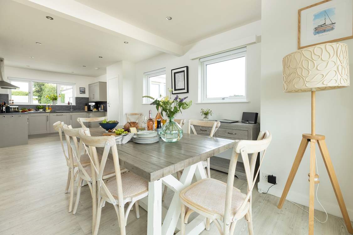 The dining-table sits in between the kitchen and sitting-room.