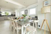 The dining-table sits in between the kitchen and sitting-room.