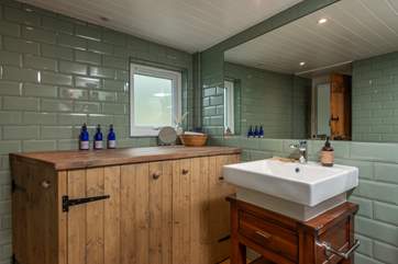 The stylish wet-room is situated on the ground floor, and also houses the washing machine and tumble-drier.