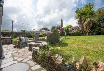 Delabole slate surrounds the fire-pit barbecue - it's a great spot to gather.