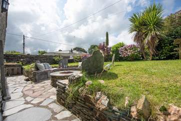 Delabole slate surrounds the fire-pit barbecue - it's a great spot to gather.