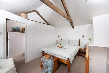 The vaulted ceiling gives the main bedroom a wonderful sense of space.