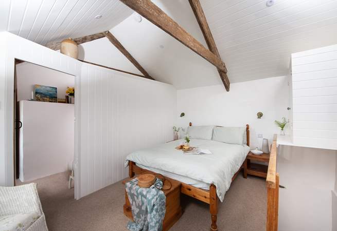 The vaulted ceiling gives the main bedroom a wonderful sense of space.