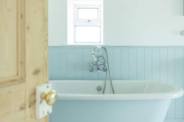 This bathroom has dual access from the hall and from bedroom five.