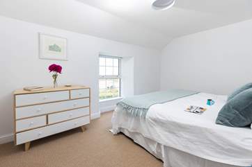 Bedroom five is accessed at the end of the hall, down a couple of steps. It has unique views towards the Bass Point and Signal Station.