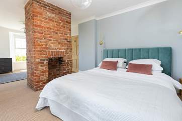 Bedroom four is the jewel in Parc Brawse House's crown. A comfy super-king size bed, ornamental fireplace and dual aspect windows with panoramic ocean views.