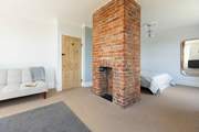 A comfy king-size bed, dual aspect ornamental fireplace and panoramic ocean views.