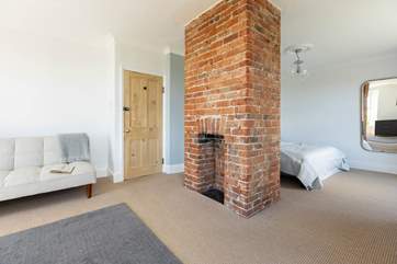A comfy king-size bed, dual aspect ornamental fireplace and panoramic ocean views.