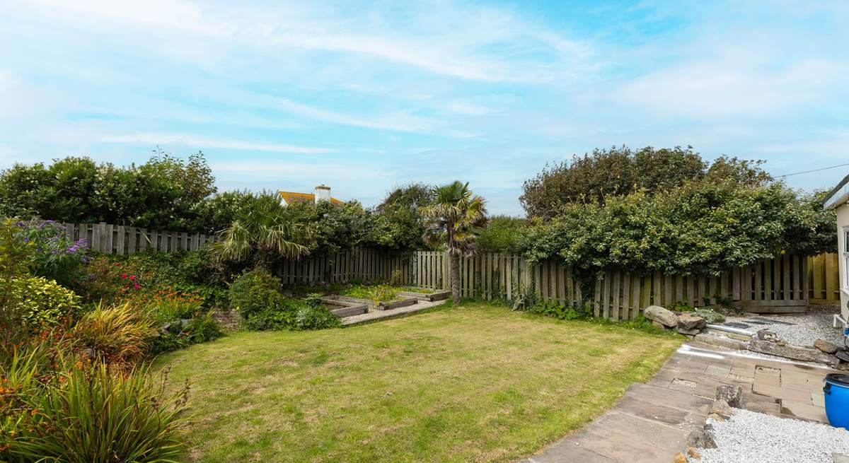 The lawn is a sun-trap in the summer. Allotments are in the rear corner. 