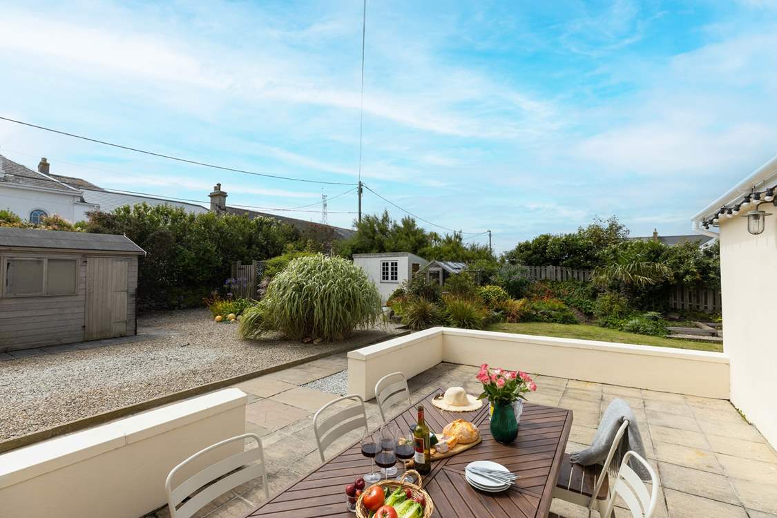 The patio is a sheltered spot, perfect for an al fresco evening. The external lighting gently creating a lovely ambience.