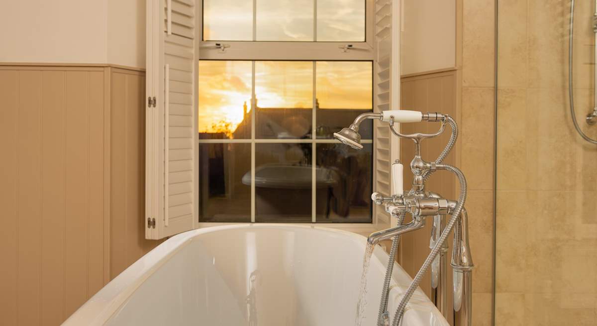 Pour yourself a glass of something ice cold and watch the sun set from the comfort of the roll-top bath. 