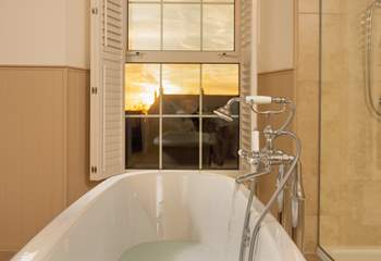 Pour yourself a glass of something ice cold and watch the sun set from the comfort of the roll-top bath. 