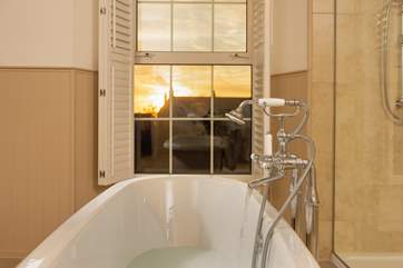 Pour yourself a glass of something ice cold and watch the sun set from the comfort of the roll-top bath.