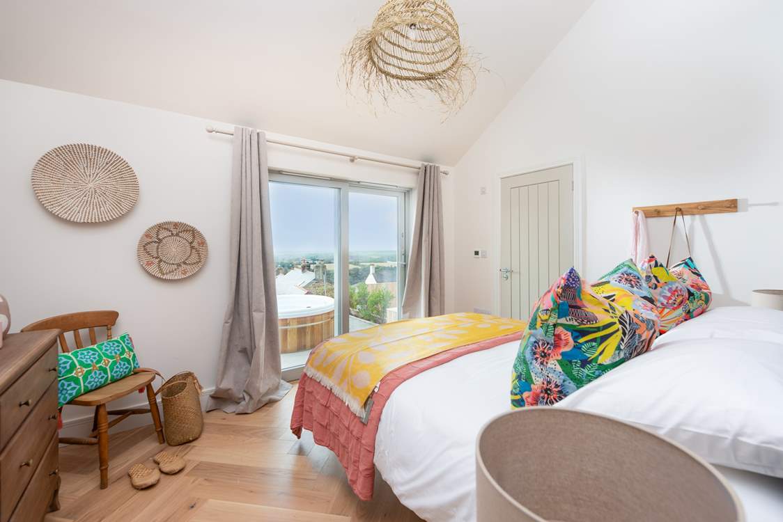 Sliding doors lead out to the decking, the perfect spot for breakfast, a wake-me-up cup of tea or a late night soak in the tub.