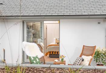 Enjoy a morning cuppa relaxing in the garden chairs outside bedroom two.