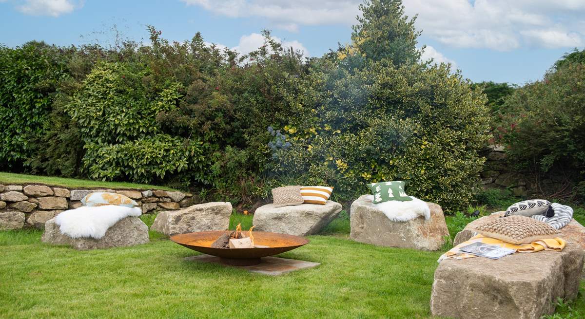 The fire-pit perfectly complements the setting, with large granite boulders as the seating.