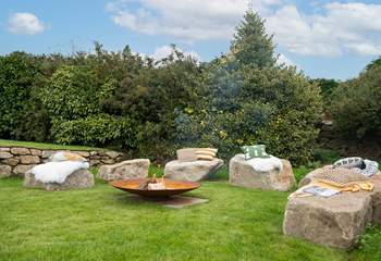 The fire-pit perfectly complements the setting, with large granite boulders as the seating.