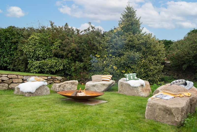 The fire-pit perfectly complements the setting, with large granite boulders as the seating.