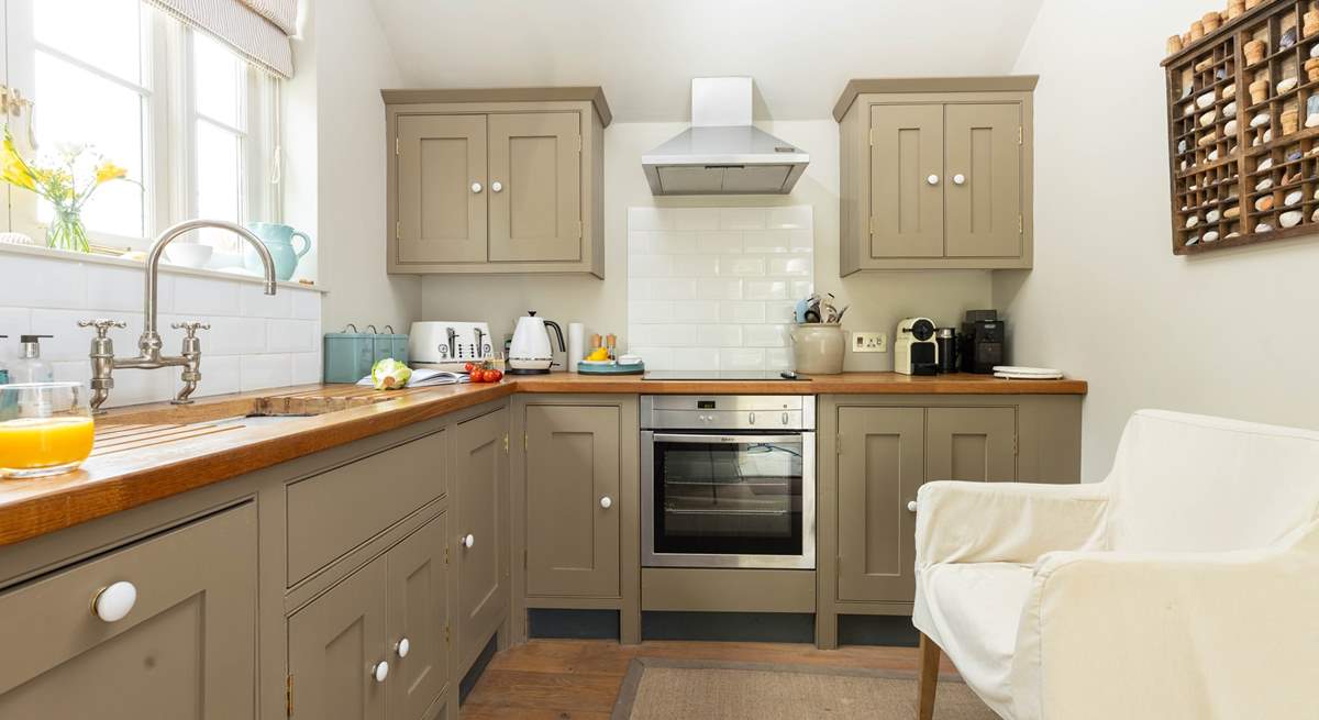 The kitchen is light and airy with the door out onto the terrace. 