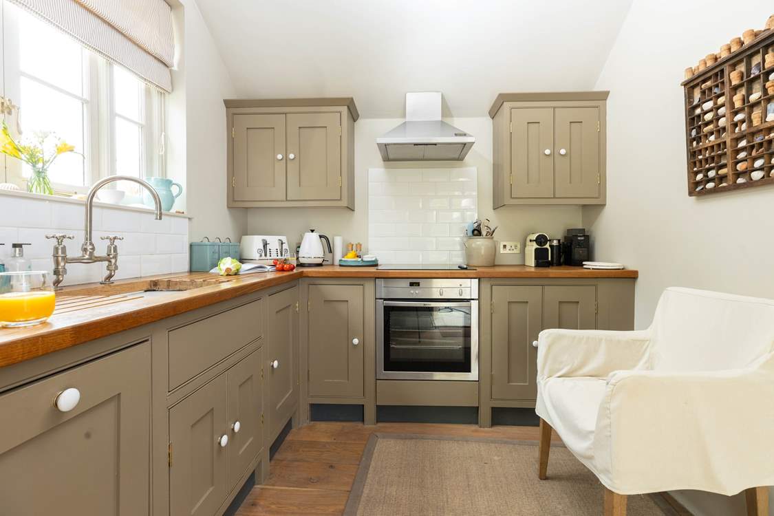 The kitchen is light and airy with the door out onto the terrace.